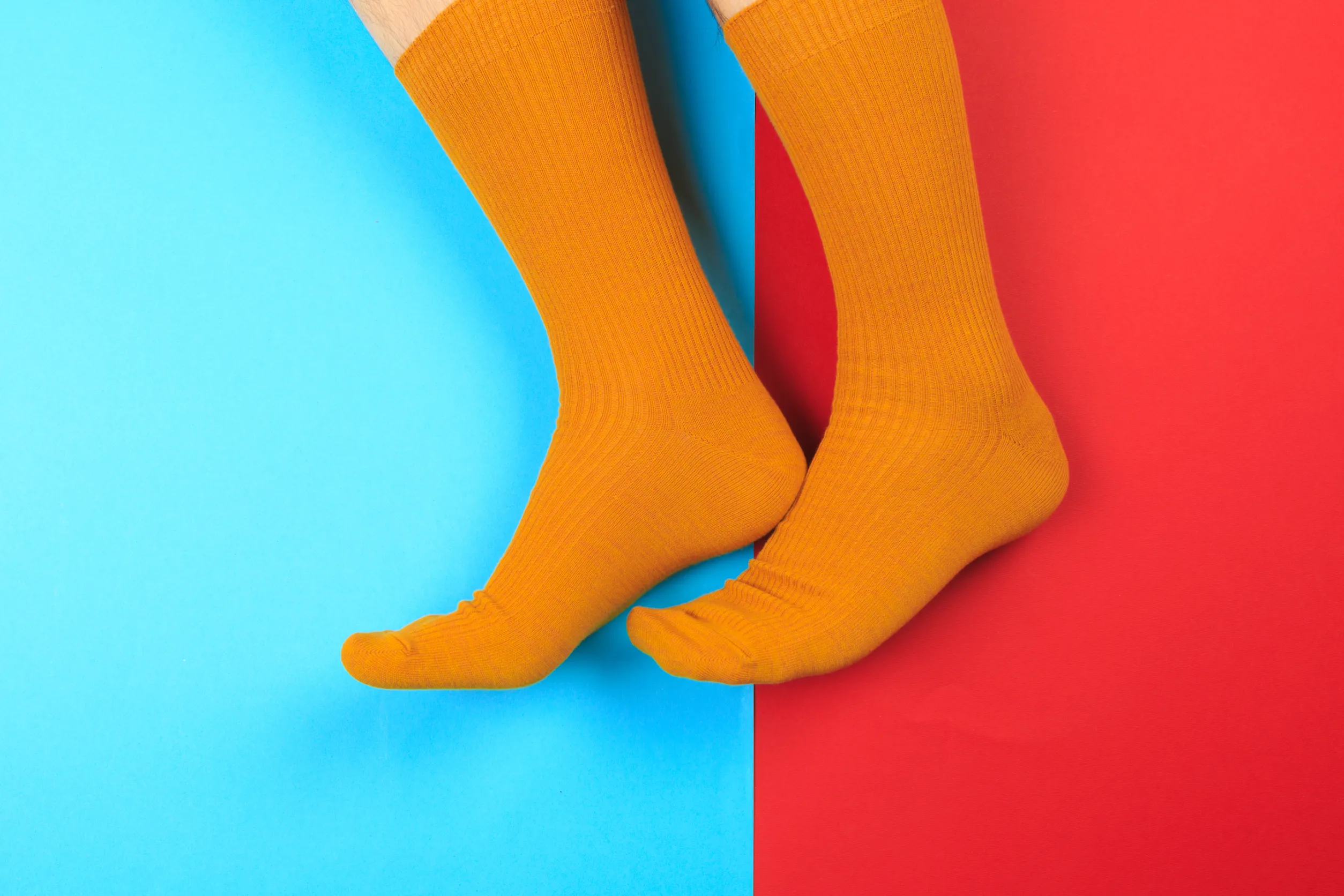 legs in colorful socks on colorful background